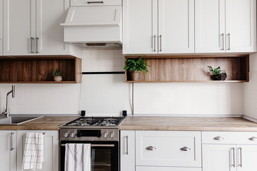 Stylish kitchen interior design. Luxury modern kitchen furniture in grey color and steel oven,...