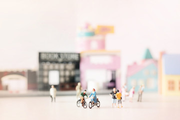 Happy young couple  (miniature) on cycle ride (miniature) on cycle ride in the city.Valentine's day background with selective focus and soft pastel color toned.