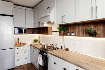  Stylish kitchen interior design. Luxury modern kitchen furniture in grey color and steel...