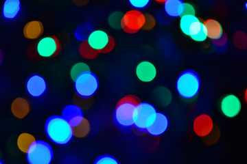 Bokeh. Christmas lights. Holiday background. Garland. Glitter. Defocused sparkles. Festive. New Year backdrop. Blinks. Carnival. Bokeh retro style photo. Multicolor. Colorful.