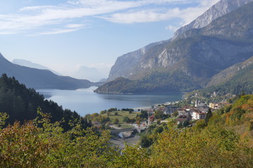 Fototapeta na wymiar Molveno Lake and Dolomites Mountains panorama with trees in the background