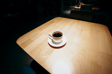 Coffe on wood table at cafe in night