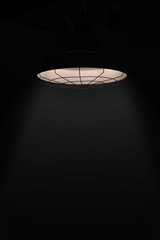 Lighting from the lamps on the ceiling and dark background