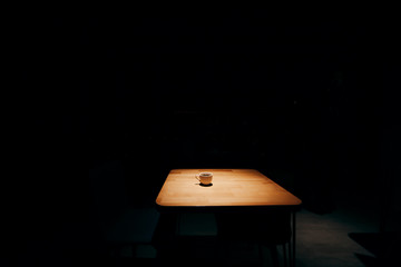 Abstract background of coffe on wood table at cafe in night