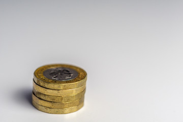 New British one pound sterling coins up close macro studio shot against white background.