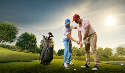 Gordijnen Male golf players on professional golf course. Golfer teaches to play golf © Alex