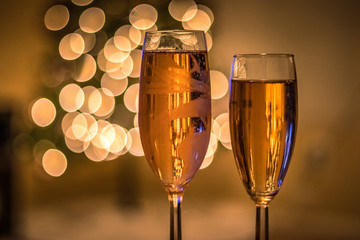 Champagne glasses in front of Christmas tree