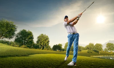 Rolgordijnen Male golf player on professional golf course. Golfer with golf club taking a shot © Alex