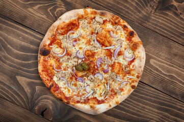 Tuna and red onion pizza on wooden background, top view