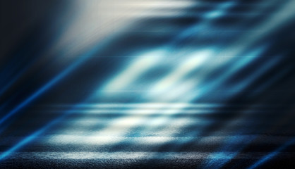 Background of empty dark room with rays of light. Concrete floor with light reflection. Smoke, neon blue light