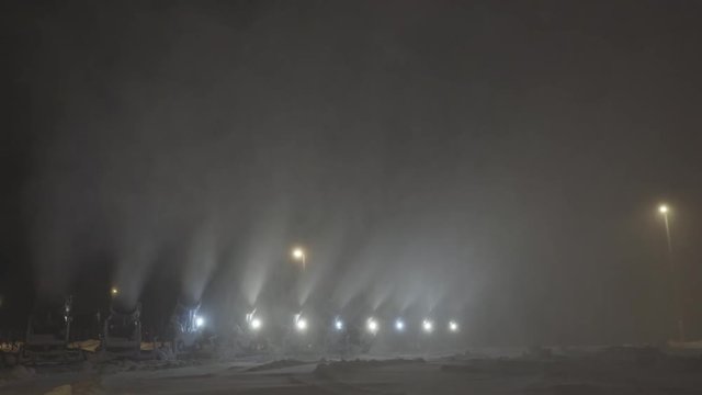 A lot of snow guns make snow at night on the ski track