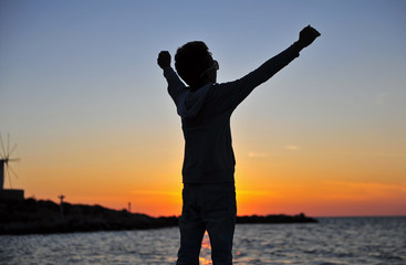 Silhouette of a boy at the sea