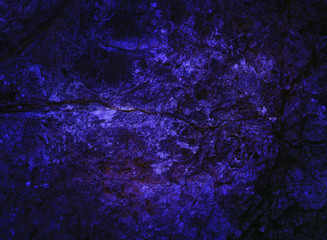 Abstract background. Rock texture. Lava surface. Mysterious stranger wall. Holographic purple neon colors. Stone background. Fantasy wallpaper. Structure background. Cosmic sky Galaxy. Stone texture