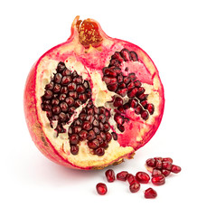 Pomegranate and seeds on white background