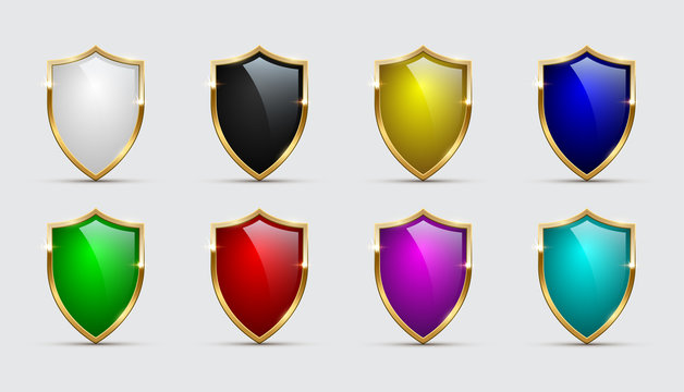 Set of color shields icons with golden frames isolated on white background. Vector design elements.