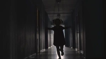 Silhouette of playful little girl with two ponytails jumping the rope towards the camera along hallway - Powered by Adobe