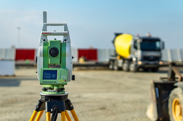 Surveyor equipment (theodolite) on construction site of the airport, building or road with...