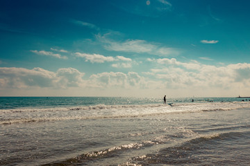 silhouette of surfers on the horizon of the mediterranean sea