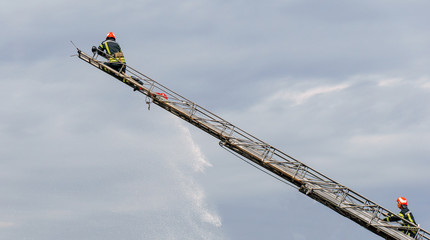 Firefighter ascends upon a ladder, equipment for rescue