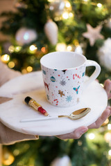 White set with a saucer and a colored mug. Festive Christmas layout.