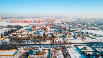 Aerial winter top down view high above rural slow living by small river.