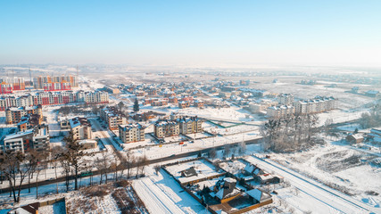Aerial winter top down view high above rural slow living by small river.