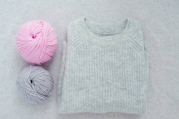 knitted sweater and soft yarn balls