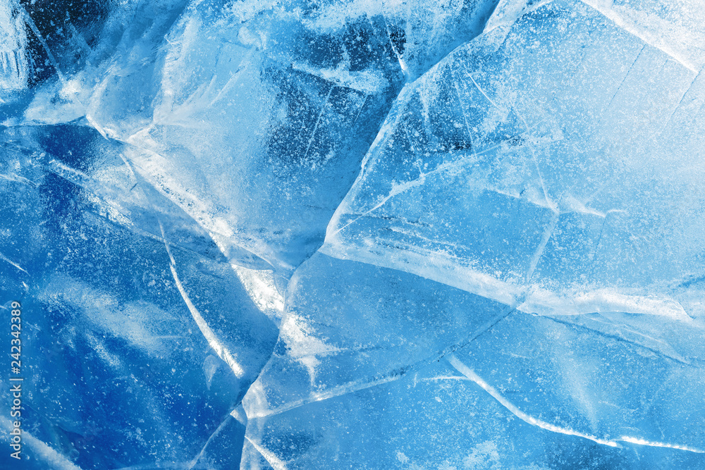 Wall mural abstract ice background. blue background with cracks on the ice surface