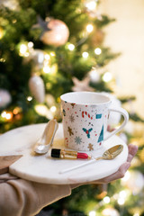 Obraz na płótnie Canvas White set with a saucer and a colored mug. Festive Christmas layout.