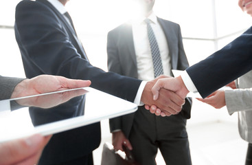 employees look at the handshake business partners