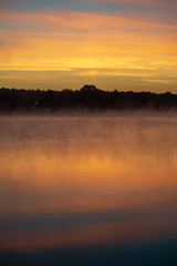 colorful misty sunset on the river in summer