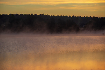 colorful misty sunset on the river in summer