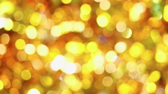Background video full of unsharp golden and yellow shining bokeh blurring gradation design.