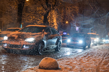 road city traffic in winter snowstorm night