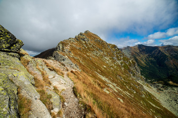 rocky Tatra mountain tourist hiking trails under blue sky in Slovakia