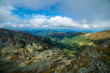 rocky Tatra mountain tourist hiking trails under blue sky in Slovakia