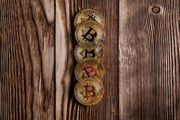 Gold Bitcoin money on wooden table. Electronic crypto currency