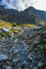 rocky Tatra mountain tourist hiking trails under blue sky in Slovakia