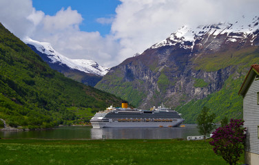 Modern Costa cruiseship cruise ship liner in Geirangerfjord, Norway on sunny day with breathtaking nature landscape scenery and glacier mountains © Tamme Wichmann