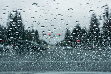 Raindrops on the windshield while driving on a rainy day, California
