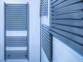 Battery. Heating appliances. Heated towel rail. a drying towel dryer built into the wall of a bright bathroom. warm battery for drying clothes