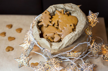 Paper bag with gingerbreads and Christmas lightings.