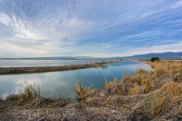 Sunset views of the ponds an levees of south San Francisco bay area, Mission Peak in the background, Sunnyvale, California