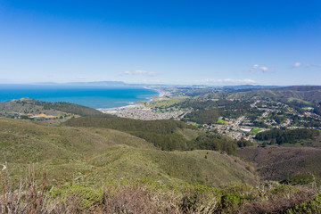 Fototapeta na wymiar Aerial view of Linda Mar and Pacifica as seen from Montara mountain, San Francisco and Marin County in the background, California