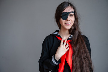 Funny girl in schoolgirl costume with glasses occluder. Ortopad Girls Eye Patches nozzle for glasses for the treatment of strabismus (lazy eye) 