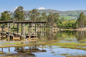 Fototapeta na wymiar Flooded meadow and picnic tables, Cunningham Lake, San Jose, south San Francisco bay, California