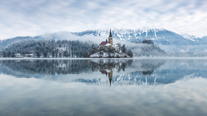 Lake bled on a misty winter morning with snow