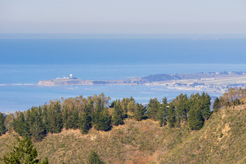 View towards the Pacific Ocean and Pillar Point Harbor from Purisima Creek Redwoods Park on a clear day; Farallon Islands visible, California