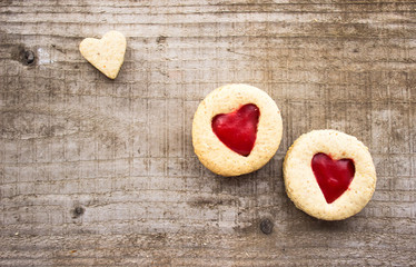 homemade linzer cookies with jam heart-shaped and decorations on wooden table free space for text - holidays, winter, celebration, Valentine's day concept