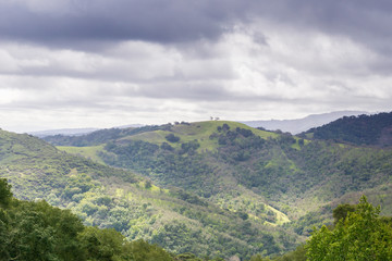 Fototapeta na wymiar Hills and valleys in Rancho Canada del Oro Open Space Preserve on a stormy spring day, California